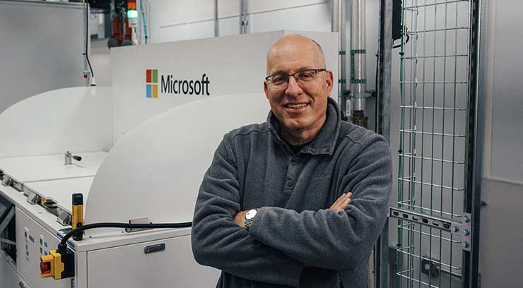Christian Belady, distinguished engineer and vice president of Microsoft’s datacenter advanced development group, stands next to a two-phase immersion cooling tank at a Microsoft data center. (Photo: Microsoft)